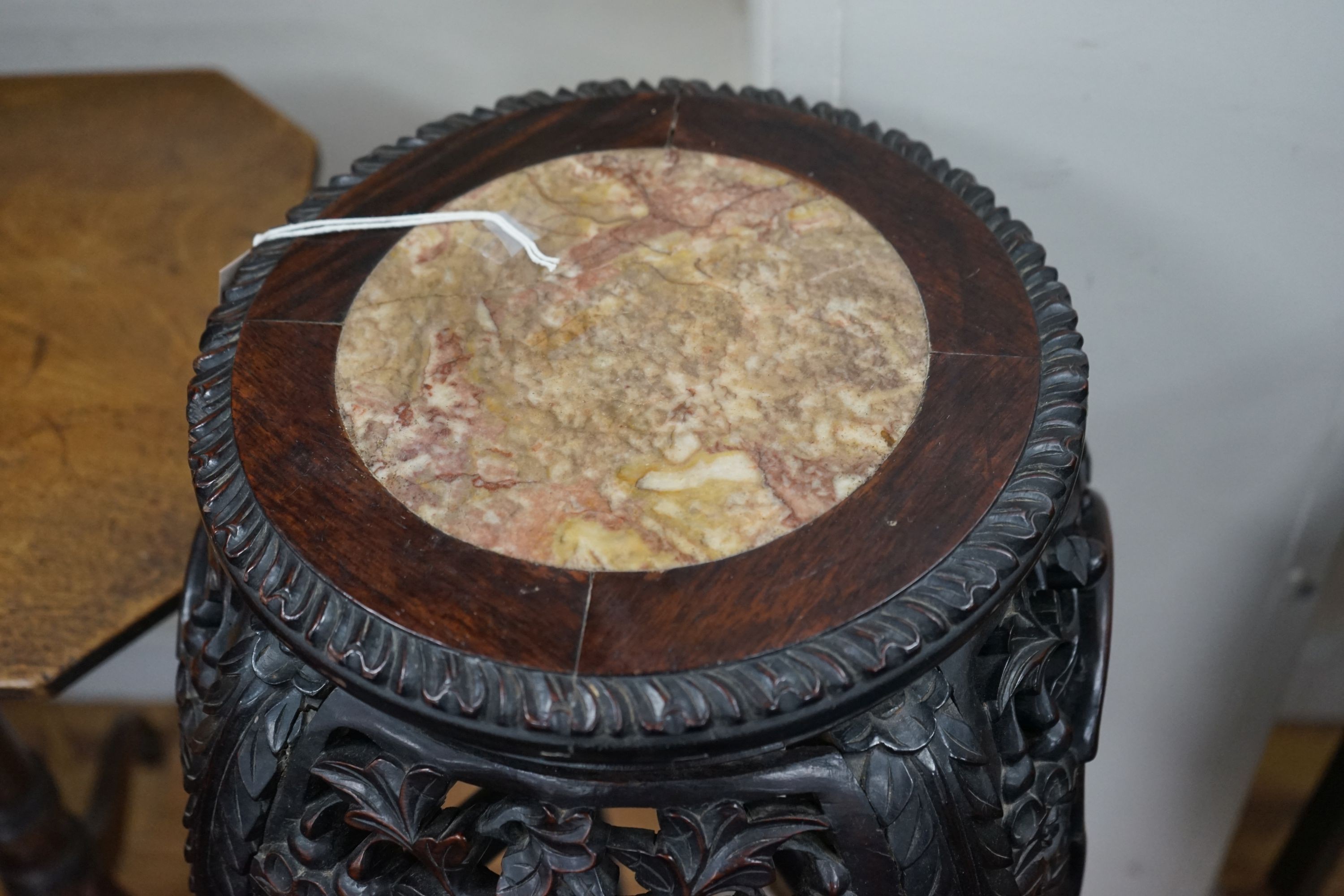 A Chinese circular marble top carved padouk jardiniere stand, height 91cm